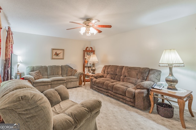 living room with ceiling fan, a textured ceiling, and light carpet