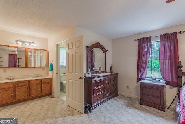 bathroom with vanity, a textured ceiling, and toilet