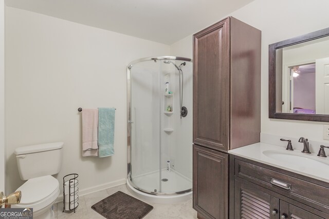 bathroom featuring tile patterned floors, walk in shower, vanity, and toilet