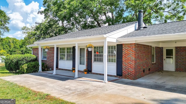 entrance to property featuring a carport