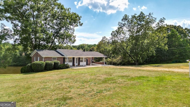 ranch-style house featuring a porch and a front yard