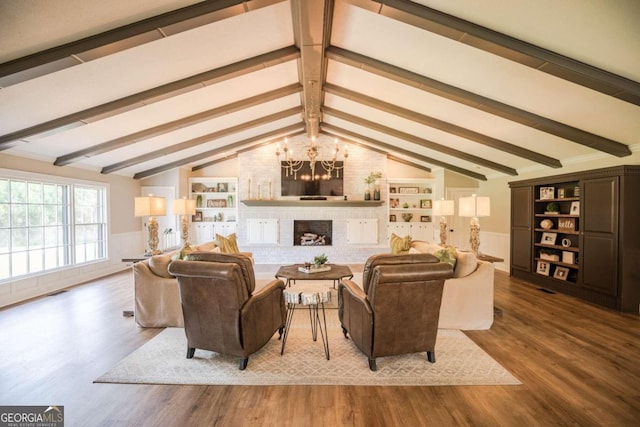 living room with a notable chandelier, brick wall, wood-type flooring, and lofted ceiling with beams