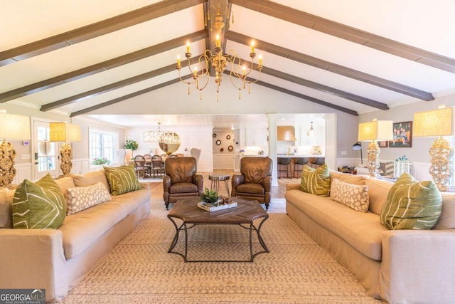 living room featuring vaulted ceiling with beams and an inviting chandelier