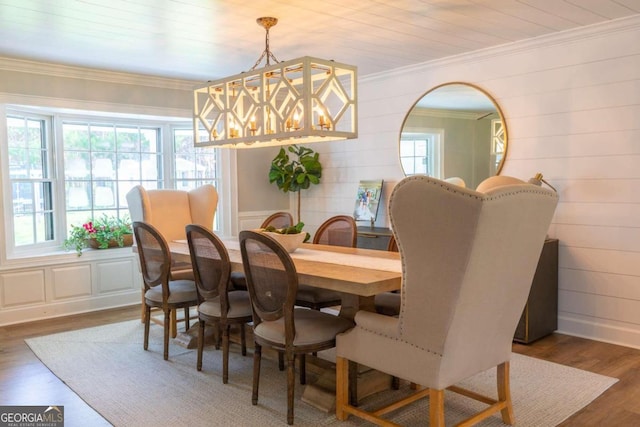 dining area featuring ornamental molding, a healthy amount of sunlight, and dark wood-type flooring