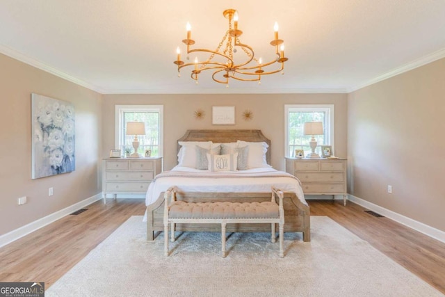 bedroom featuring multiple windows, light wood-type flooring, and ornamental molding