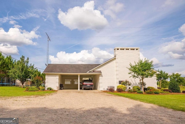 view of front of property with cooling unit, a carport, and a front yard