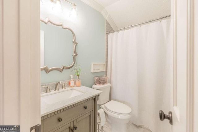 bathroom with tile patterned floors, crown molding, toilet, and vanity