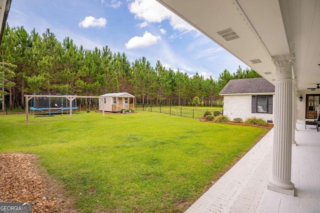 view of yard with a patio area and a trampoline