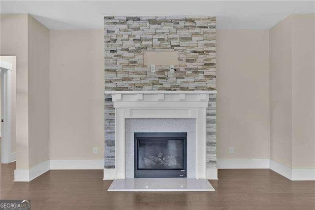 interior details with a fireplace and wood-type flooring