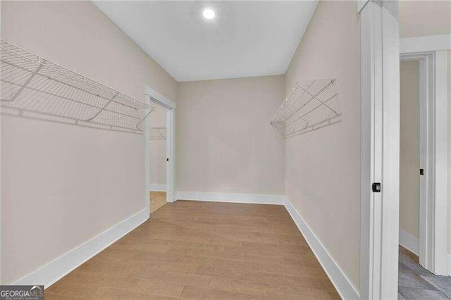 spacious closet with light hardwood / wood-style flooring