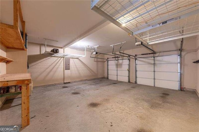 garage with electric panel and a garage door opener