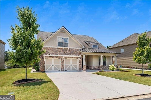 craftsman inspired home featuring a garage and a front lawn