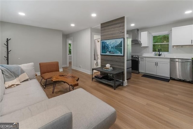 living room with sink and light hardwood / wood-style floors