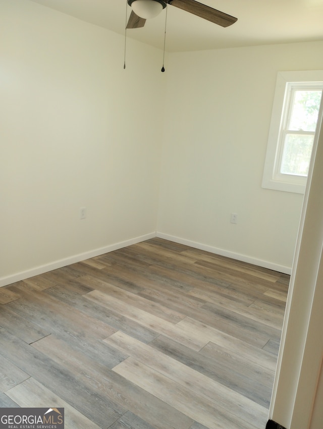 spare room with ceiling fan and hardwood / wood-style floors