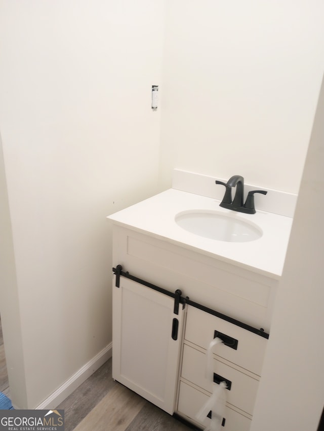 bathroom featuring vanity and hardwood / wood-style flooring