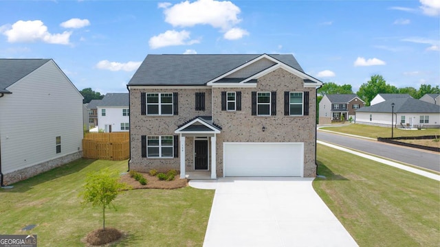 view of front of house featuring a garage and a front yard