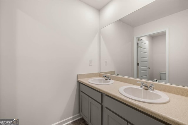 bathroom featuring vanity and toilet