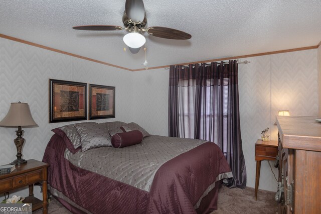 bedroom featuring ceiling fan, ornamental molding, a textured ceiling, and carpet