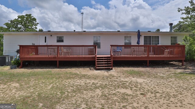 rear view of property with a wooden deck and central air condition unit