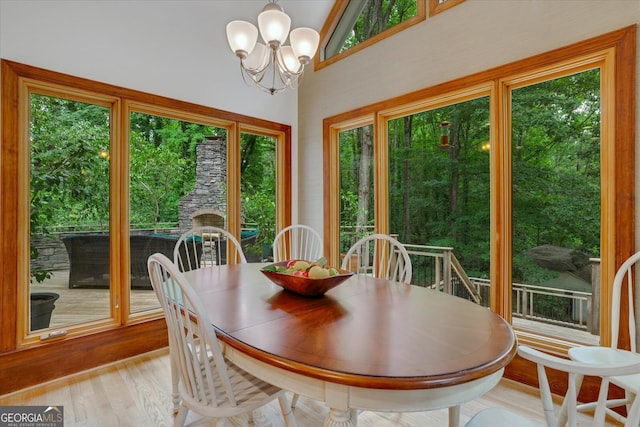 dining area featuring a notable chandelier, light hardwood / wood-style flooring, and a wealth of natural light