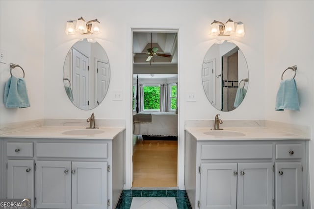 bathroom with wood-type flooring, ceiling fan, and dual bowl vanity