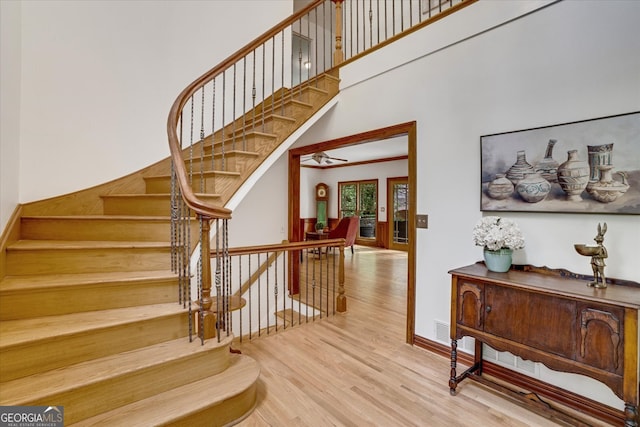 stairway with hardwood / wood-style flooring