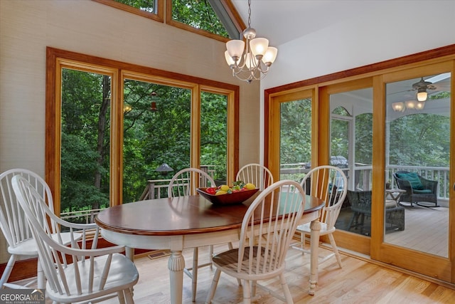 dining area with a healthy amount of sunlight, a notable chandelier, and light hardwood / wood-style floors