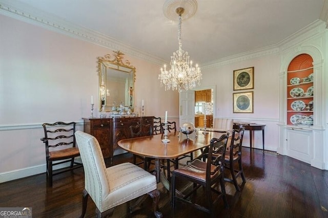 dining room with dark wood-type flooring, crown molding, and an inviting chandelier