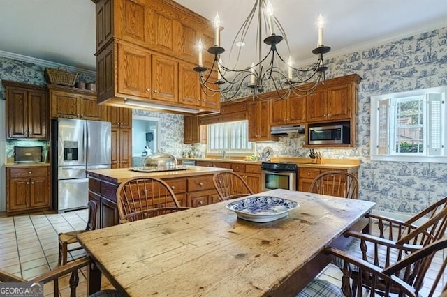 71 Taff Rd, Taylorsville, GA 30178 - kitchen with stainless steel appliances, wallpapered walls, under cabinet range hood, a center island, and a chandelier