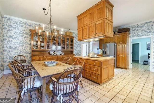 kitchen featuring crown molding, kitchen peninsula, pendant lighting, and light tile patterned floors