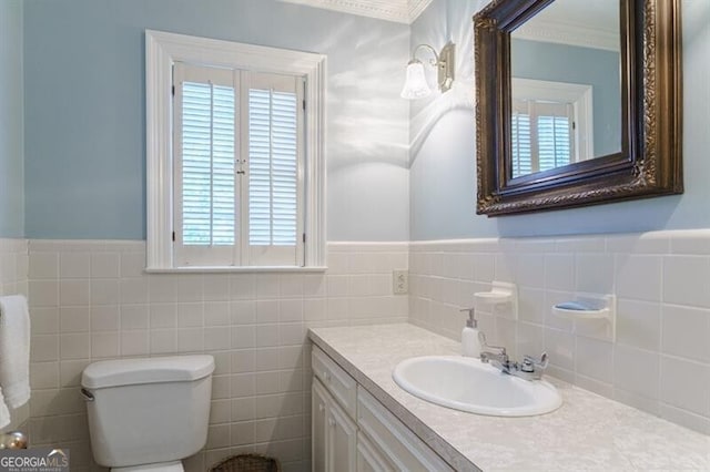 bathroom with toilet, a healthy amount of sunlight, backsplash, and tile walls