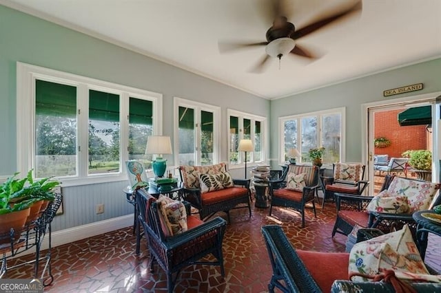 sunroom featuring ceiling fan