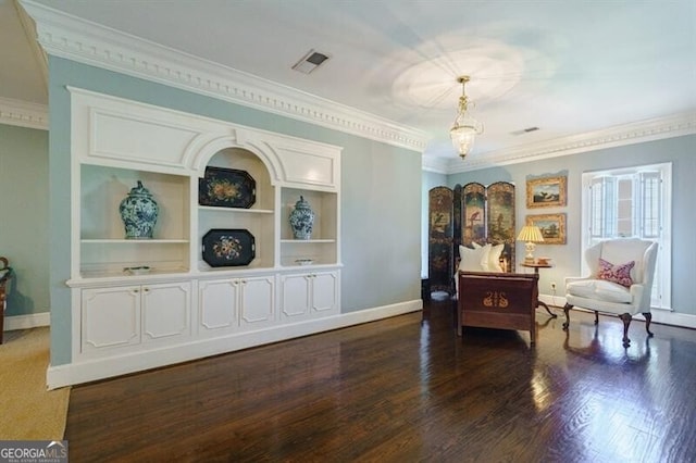 living area with built in features, dark wood-type flooring, and ornamental molding