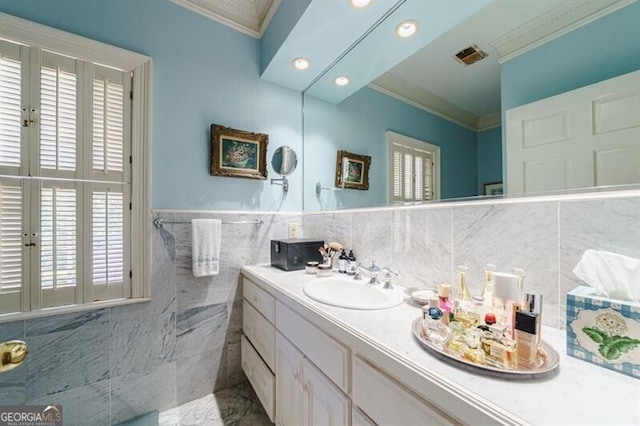 bathroom with vanity, tile walls, tasteful backsplash, and ornamental molding