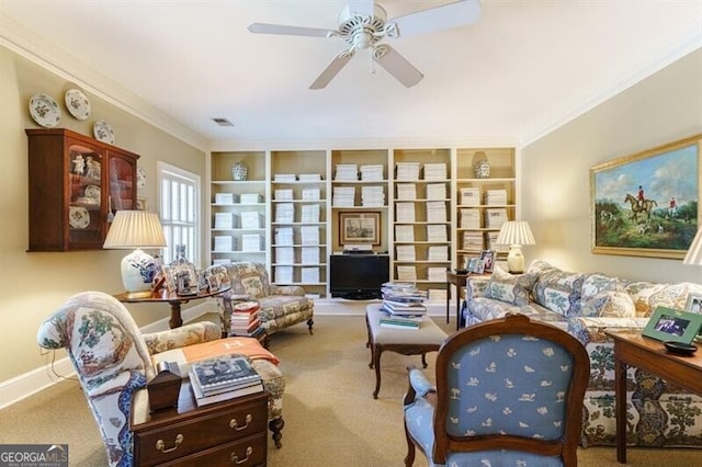 carpeted living room featuring ceiling fan and ornamental molding