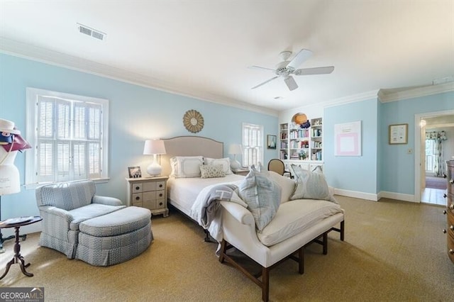 carpeted bedroom featuring ceiling fan and crown molding