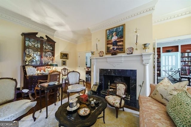 living room with a fireplace, hardwood / wood-style flooring, and ornamental molding