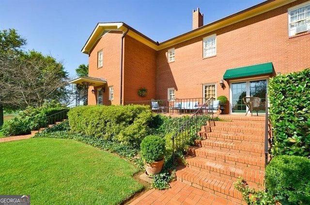 71 Taff Rd, Taylorsville, GA 30178 - back of property featuring a chimney, a patio, and brick siding