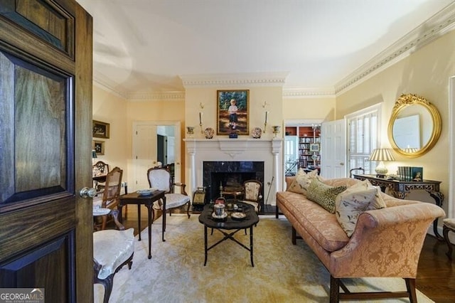 living room with a fireplace, crown molding, and hardwood / wood-style floors