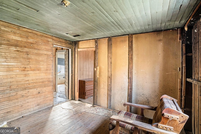 misc room featuring wood ceiling and wood walls