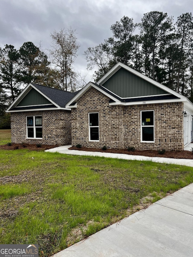 view of front of property with a garage and a front lawn