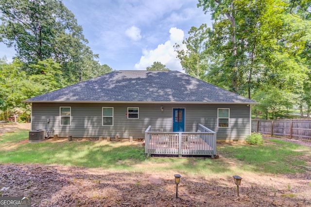 back of house featuring cooling unit, a yard, and a deck