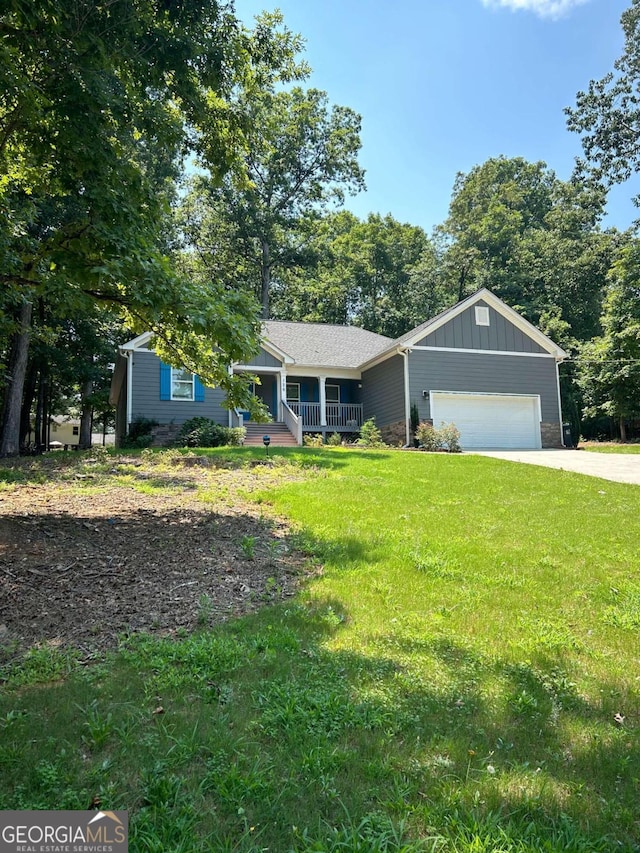 ranch-style home featuring a garage, a front yard, and covered porch