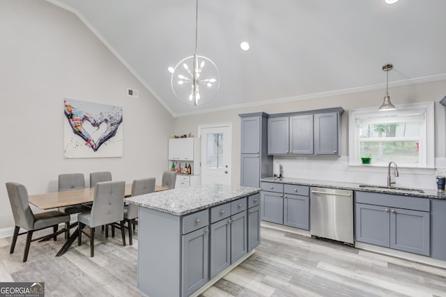 kitchen featuring sink, gray cabinetry, stainless steel dishwasher, pendant lighting, and decorative backsplash