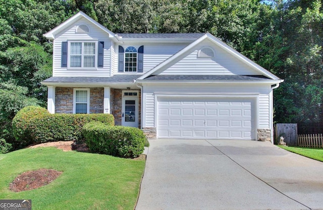 view of front property featuring a garage and a front yard