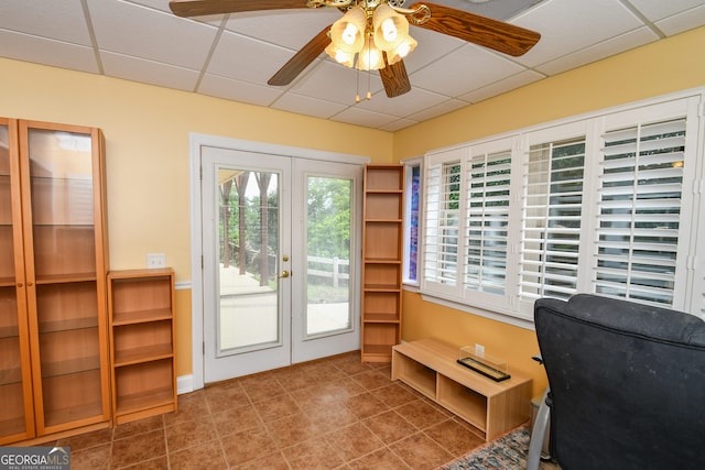 tiled office space featuring a drop ceiling, french doors, and ceiling fan