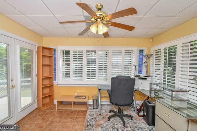 tiled office featuring ceiling fan and a paneled ceiling