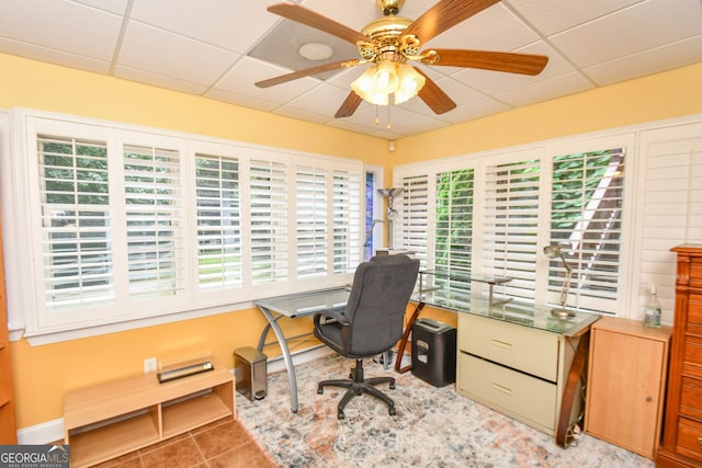 tiled office featuring a drop ceiling and ceiling fan