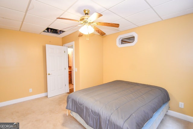 carpeted bedroom with a drop ceiling and ceiling fan