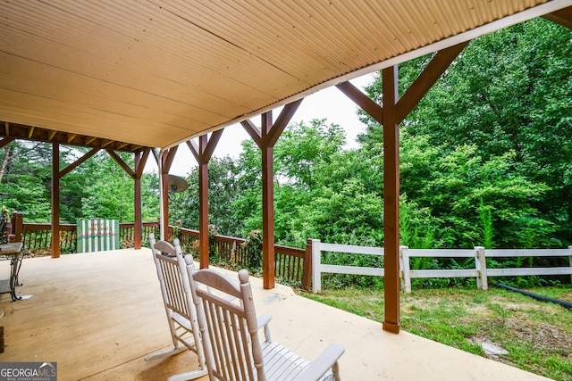 wooden terrace with a patio area